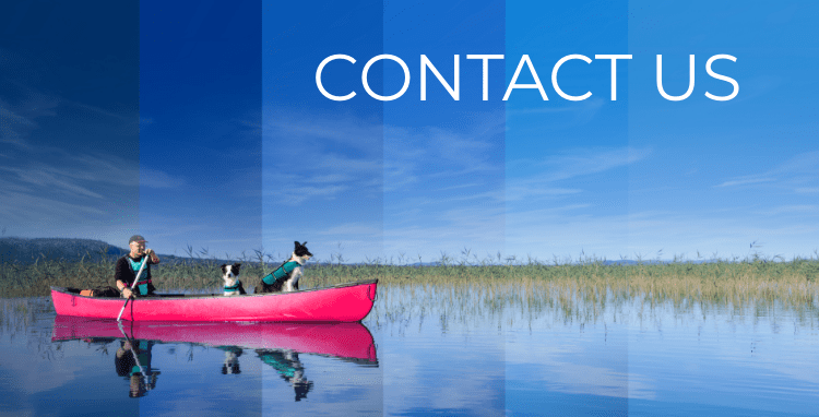 Man and two dogs on a red canoe 